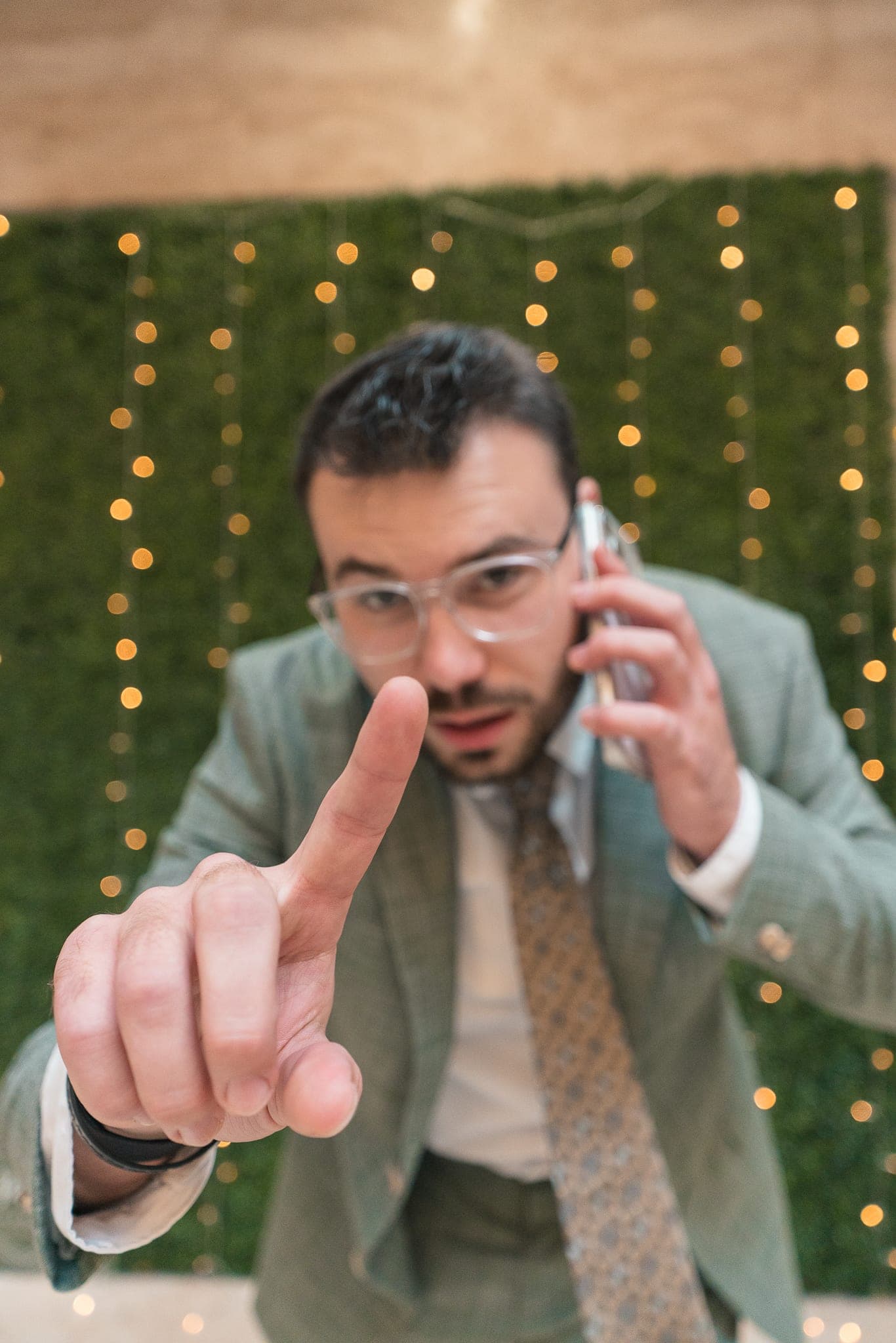 Donny, on phone, pointing at camera