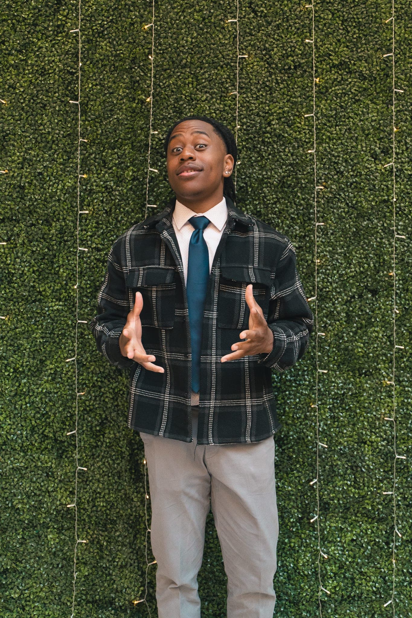 Rep in plaid overshirt + tie, mid-conversation