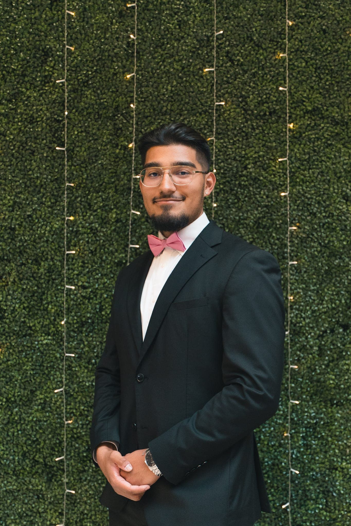 Rep in black suit + bow tie, composed portrait