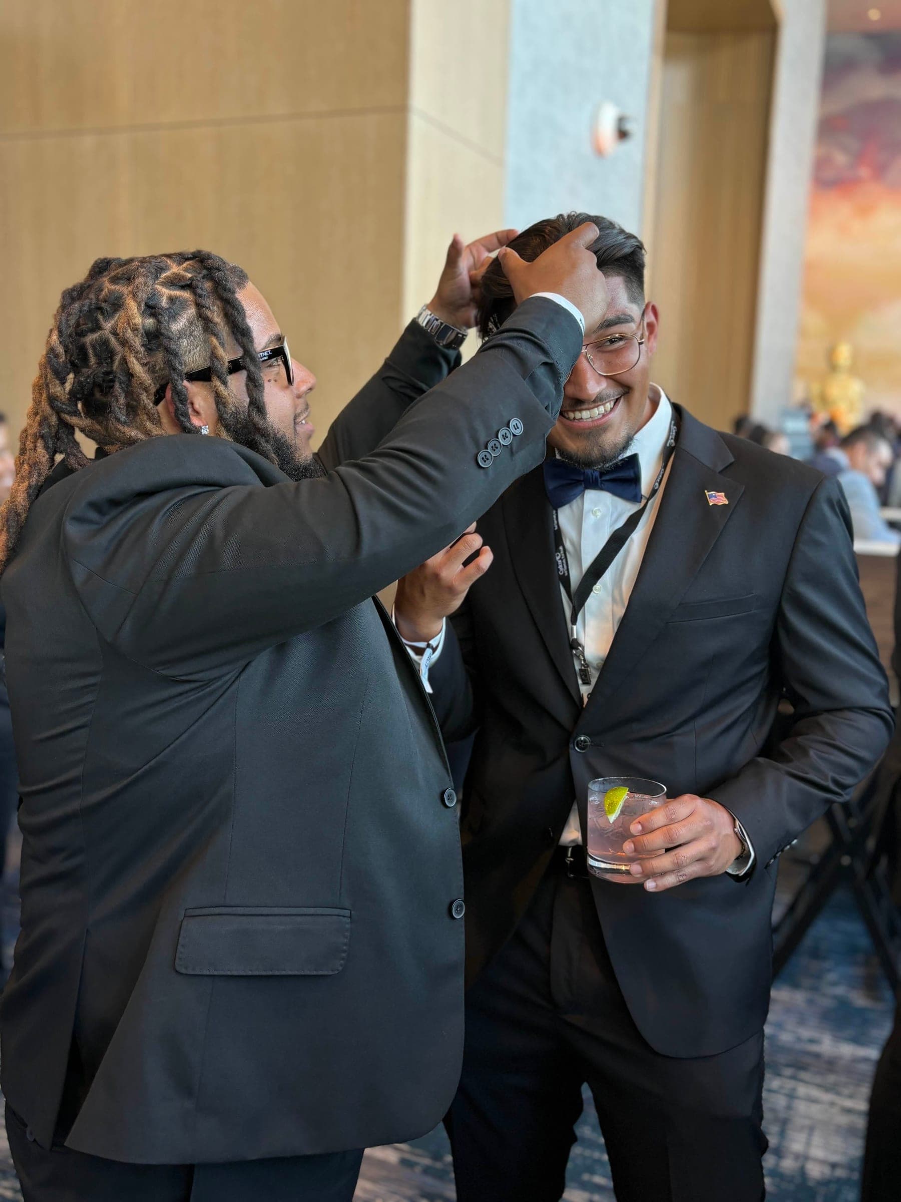 Candid at a formal event, fixing a teammate's hair